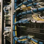 Close-up of a neatly organized section of modern server racks with integrated network hardware
